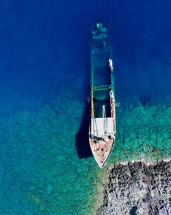 High angle view of abandoned boat in sea during sunny day