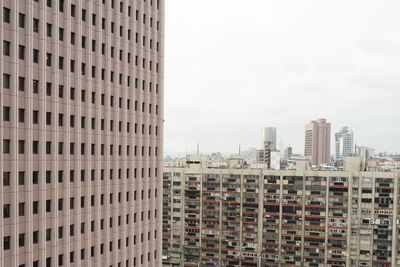 Modern buildings in city against sky