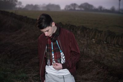 Young man looking down on field