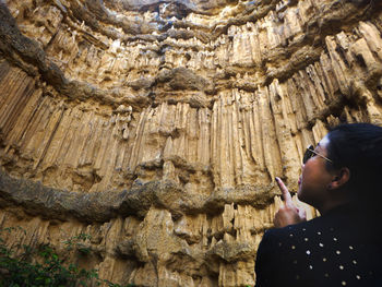 Low angle view of man holding rock