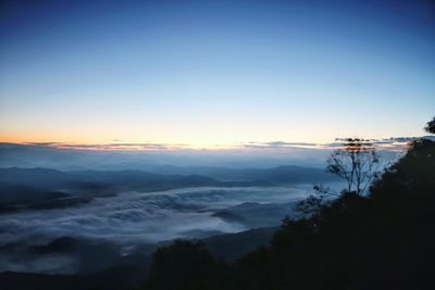 Scenic view of mountains against clear sky during sunset