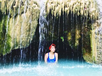 Portrait of mid adult woman wearing bikini standing in river