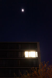 Low angle view of illuminated building against sky at night