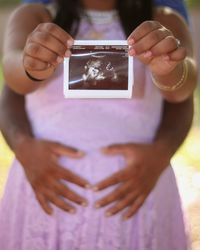 Midsection of pregnant woman with x-ray image