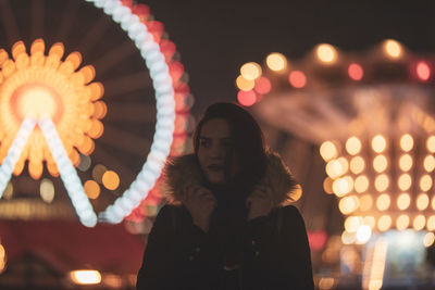 High angle view of woman standing against illuminated lights