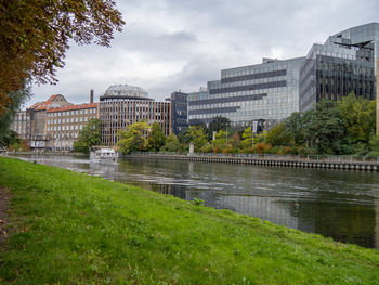 Bridge over river against cloudy sky