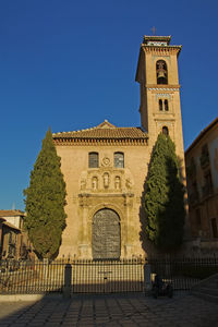 Low angle view of historical building against clear blue sky