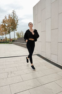 Low section of woman walking on street