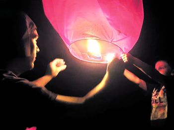 Midsection of man holding illuminated lighting equipment