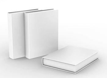 Close-up of open book on table against white background