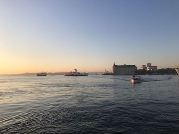 Scenic view of sea against clear sky during sunset