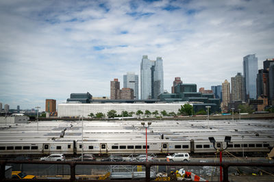 View of cityscape against cloudy sky