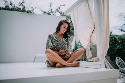 Woman sitting on table