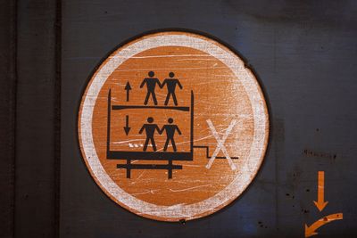 Close-up of two people crossing sign