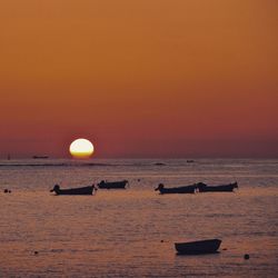 Scenic view of sea against orange sky