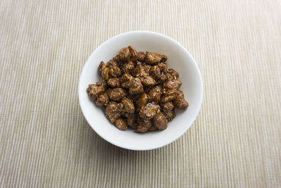 High angle view of candied almonds in bowl on table