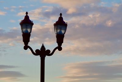 Low angle view of street light against sky at sunset