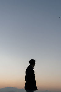 Low angle view of man against sky during sunset