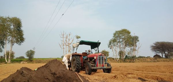 Tractor on field against sky