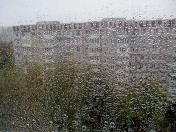 Raindrops on glass window of rainy season