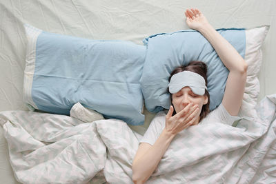 Young woman sleeping on bed at home