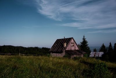 House on field against sky