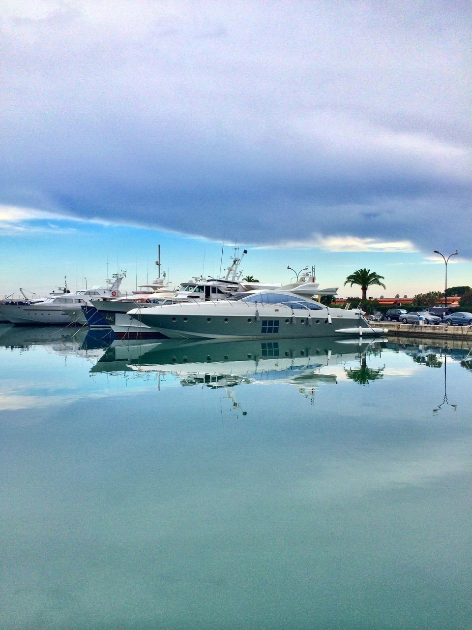 sky, water, nautical vessel, cloud - sky, cloudy, transportation, harbor, built structure, waterfront, architecture, mode of transport, weather, boat, building exterior, moored, cloud, lake, nature, reflection, day