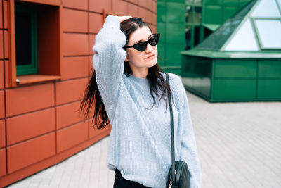 Young woman wearing sunglasses standing outdoors