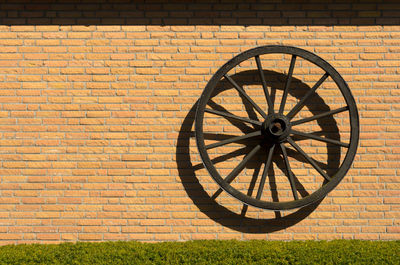 Shadow of wheel on brick wall