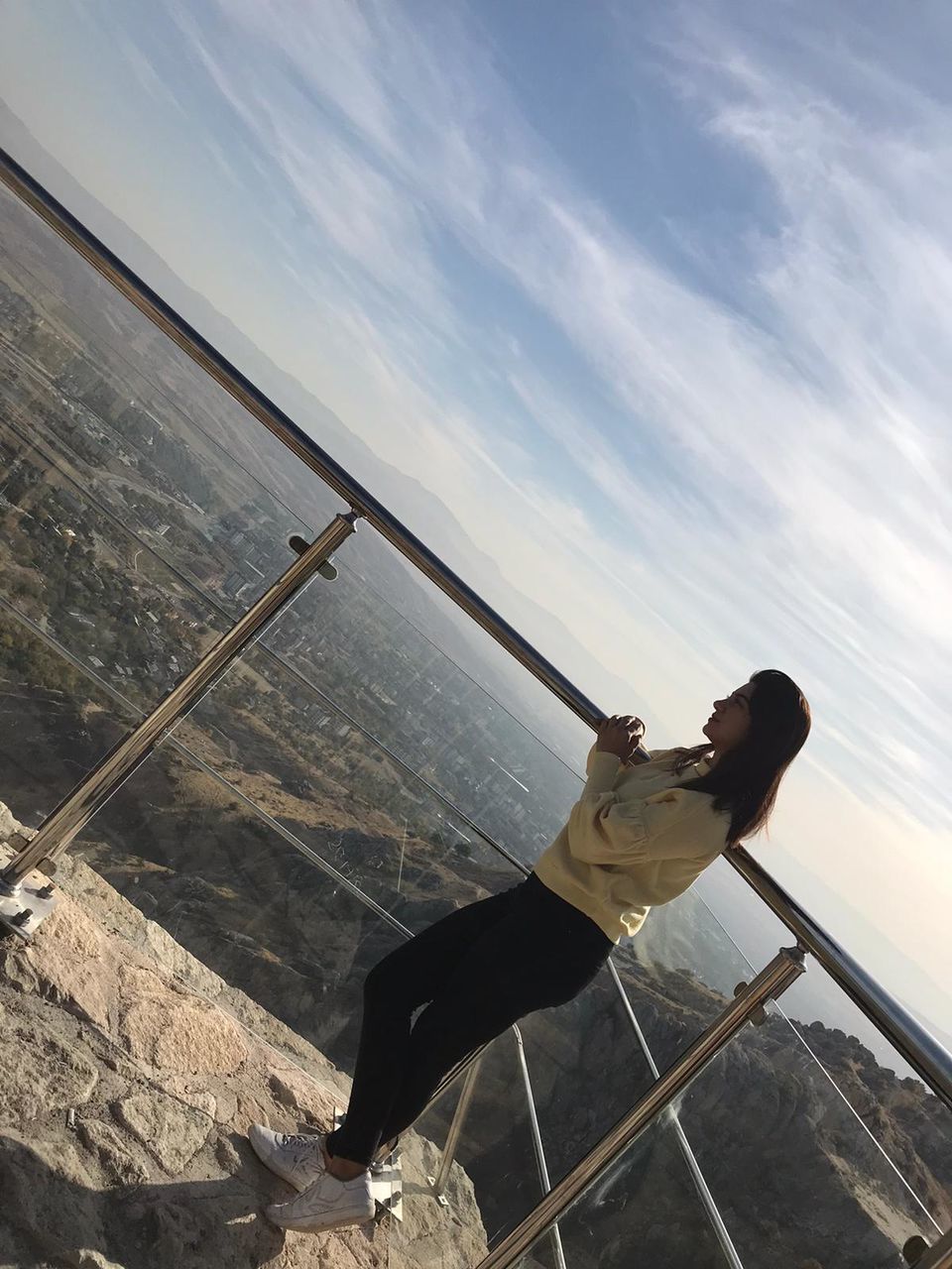 sky, cloud - sky, nature, real people, one person, railing, water, sea, beauty in nature, leisure activity, day, scenics - nature, lifestyles, outdoors, architecture, holding, horizon over water, built structure, hand-held telescope