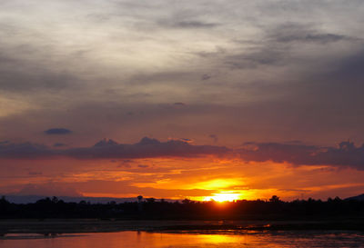 Scenic view of lake against romantic sky at sunset