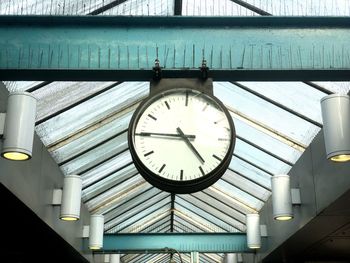 Low angle view of clock on ceiling at railroad station