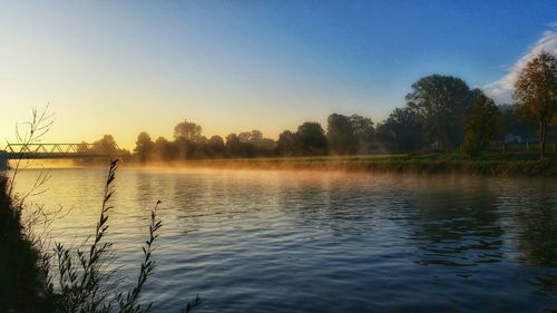 Scenic view of lake at sunset