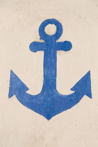 Close-up of arrow sign on wall