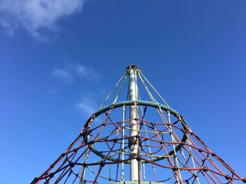 Low angle view of ferris wheel against blue sky