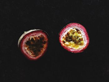 Sliced passion fruit against black background
