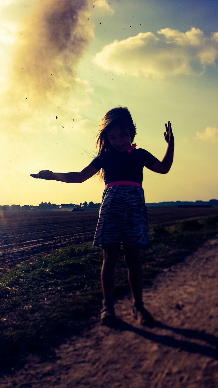 full length, leisure activity, lifestyles, sky, childhood, field, girls, sunset, casual clothing, cloud - sky, standing, boys, landscape, enjoyment, fun, elementary age, carefree, rear view