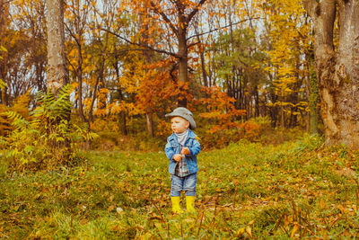 Full length of a man standing in forest