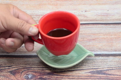 Midsection of person holding tea cup