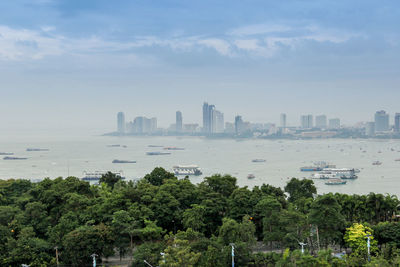 Scenic view of sea by city against sky