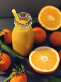 High angle view of fruits and drink on table