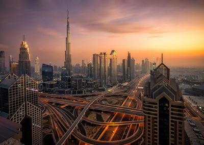 High angle view of buildings against cloudy sky during sunset