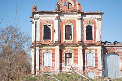 Low angle view of old building against clear blue sky