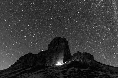 Low angle view of rock formations against sky at night