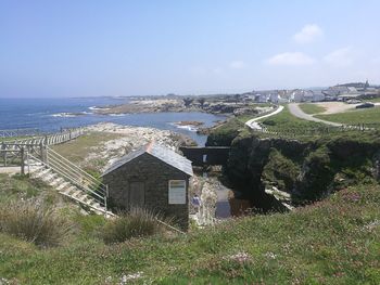 Scenic view of sea and buildings against sky