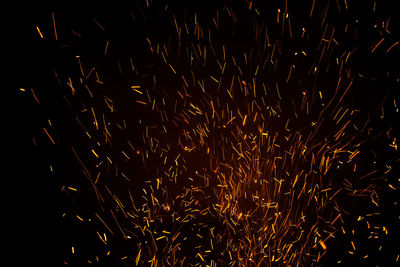 Low angle view of firework display at night