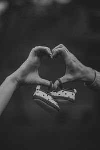 Cropped hands of couple holding baby booties