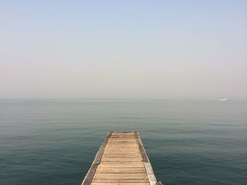 Pier over sea against clear sky