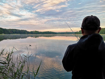 Rear view of man standing in lake