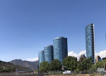 Low angle view of buildings against clear blue sky